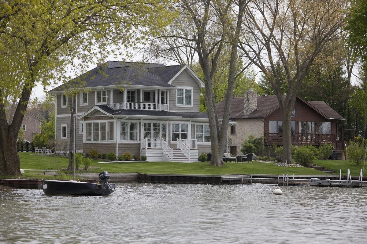 Waterfront home in Fox Lake beneath mature trees